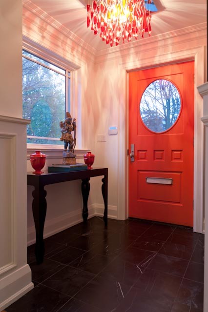 This is an example of a mid-sized eclectic front door in Toronto with white walls, slate floors, a single front door and a red front door.