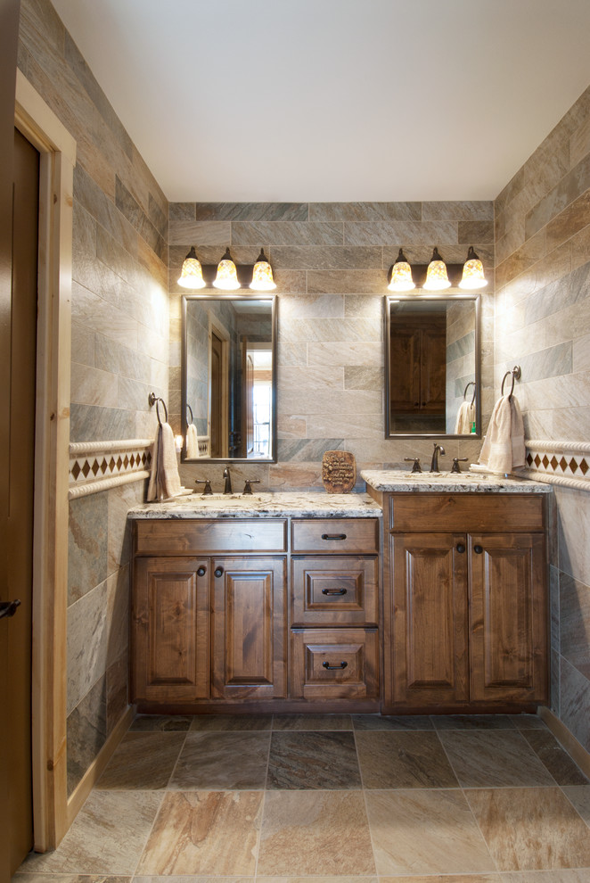 Inspiration for a mid-sized country master bathroom in Dallas with an undermount sink, raised-panel cabinets, medium wood cabinets, granite benchtops, an alcove tub, a two-piece toilet, multi-coloured tile, porcelain tile, multi-coloured walls and porcelain floors.