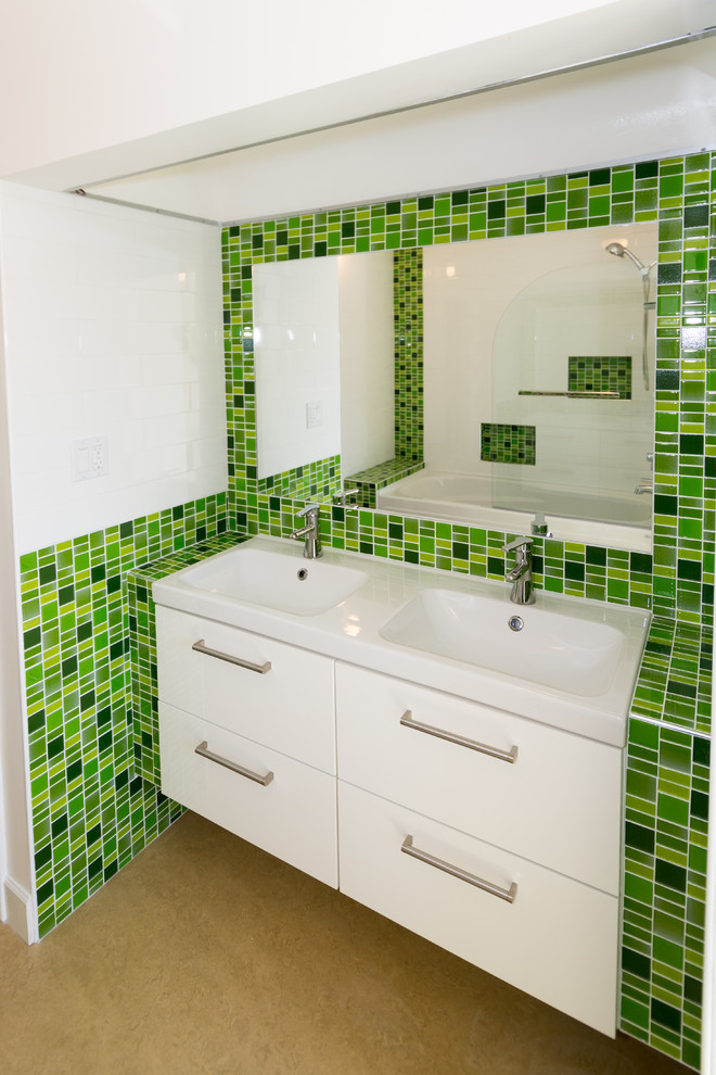 Design ideas for a small contemporary master bathroom in Vancouver with an integrated sink, flat-panel cabinets, white cabinets, tile benchtops, a drop-in tub, a shower/bathtub combo, a two-piece toilet, green tile, glass sheet wall, white walls and linoleum floors.