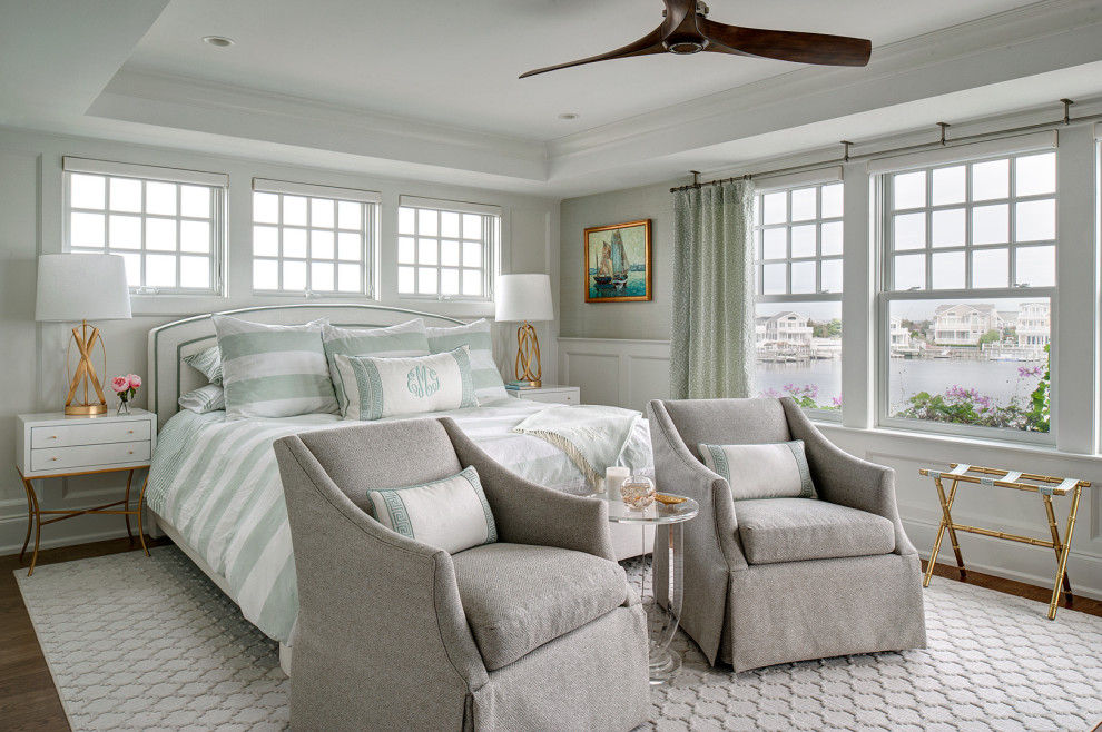 Design ideas for a beach style master bedroom in Philadelphia with grey walls, medium hardwood floors, no fireplace, brown floor, recessed, panelled walls and decorative wall panelling.