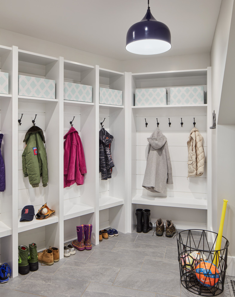 Photo of a medium sized classic boot room in Boston with grey floors.