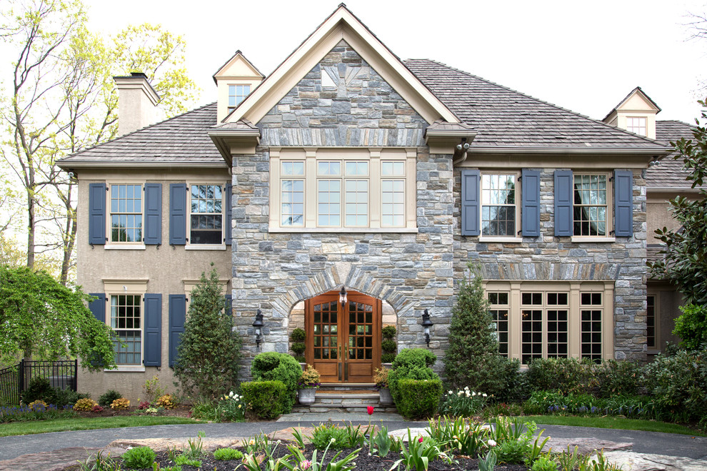 Design ideas for a traditional exterior in Philadelphia with stone veneer and a hip roof.