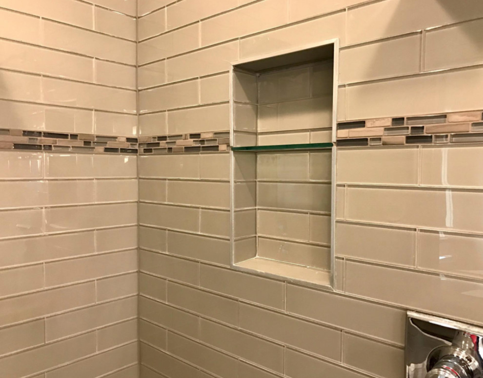 Example of a large transitional master gray tile and glass tile mosaic tile floor and multicolored floor alcove shower design with gray walls and a hinged shower door