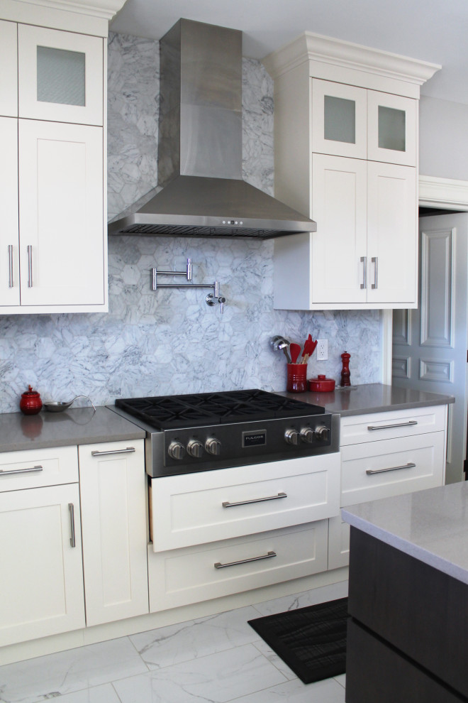 Inspiration for a large transitional u-shaped eat-in kitchen remodel with shaker cabinets, white cabinets, quartz countertops, gray backsplash, stainless steel appliances, an island and gray countertops