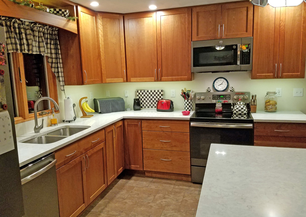 Example of a mid-sized transitional l-shaped ceramic tile and green floor eat-in kitchen design with an undermount sink, shaker cabinets, medium tone wood cabinets, quartz countertops, stainless steel appliances, an island and white countertops
