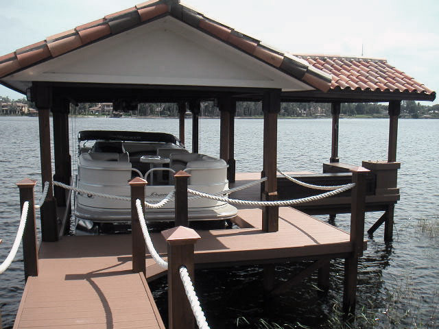 This is an example of a small eclectic backyard deck in Orlando with with dock.