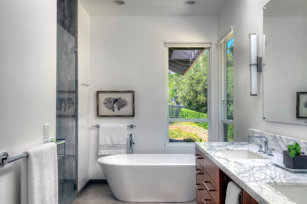 Photo of a contemporary bathroom in San Francisco with an undermount sink, a freestanding tub, a curbless shower and a one-piece toilet.