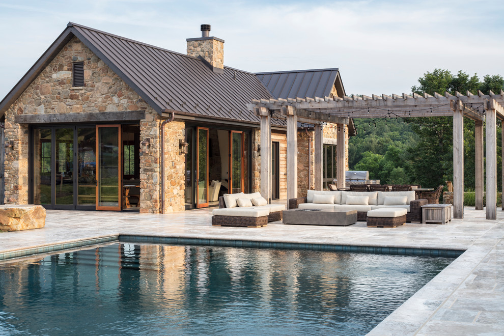 This is an example of a large country backyard rectangular lap pool in DC Metro with natural stone pavers.