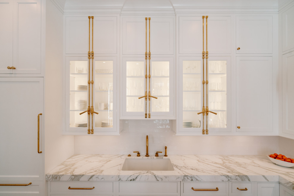 Mid-sized transitional l-shaped medium tone wood floor and brown floor eat-in kitchen photo with an undermount sink, beaded inset cabinets, white cabinets, marble countertops, white backsplash, subway tile backsplash, paneled appliances, an island and gray countertops