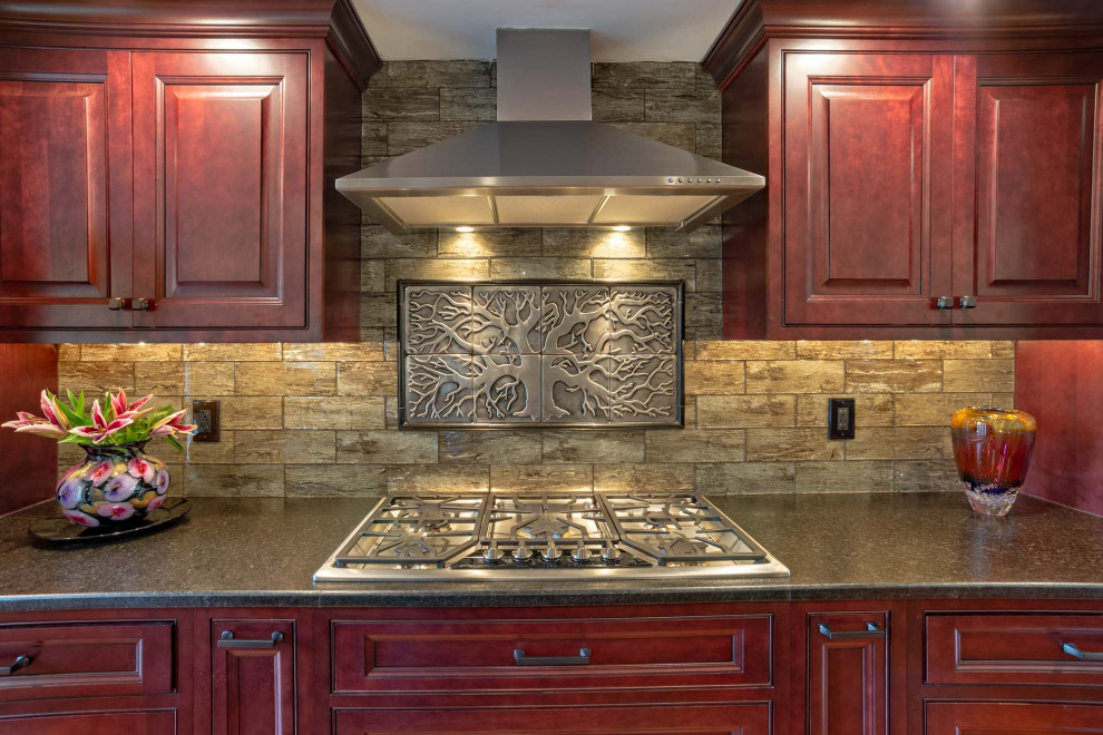 Inspiration for a large transitional single-wall light wood floor and brown floor eat-in kitchen remodel in Philadelphia with an undermount sink, raised-panel cabinets, red cabinets, granite countertops, brown backsplash, porcelain backsplash, stainless steel appliances, an island and brown countertops