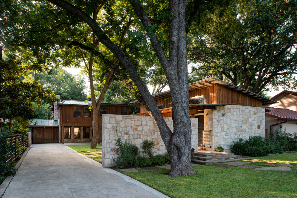 Photo of a contemporary exterior in Austin with wood siding and a shed roof.