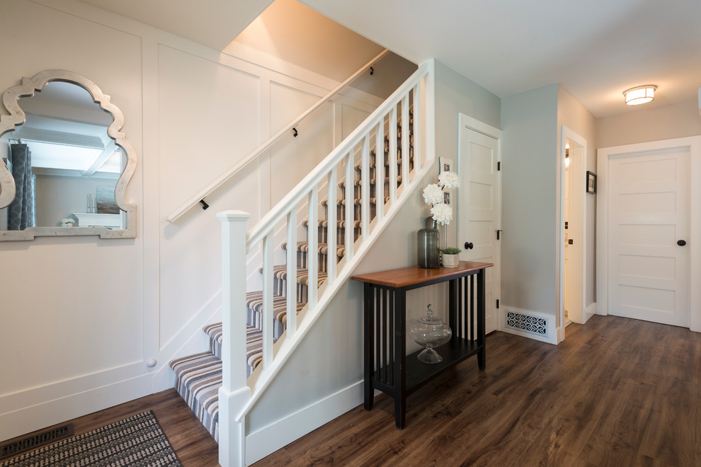 Front door - mid-sized transitional medium tone wood floor front door idea in Vancouver with gray walls and a white front door