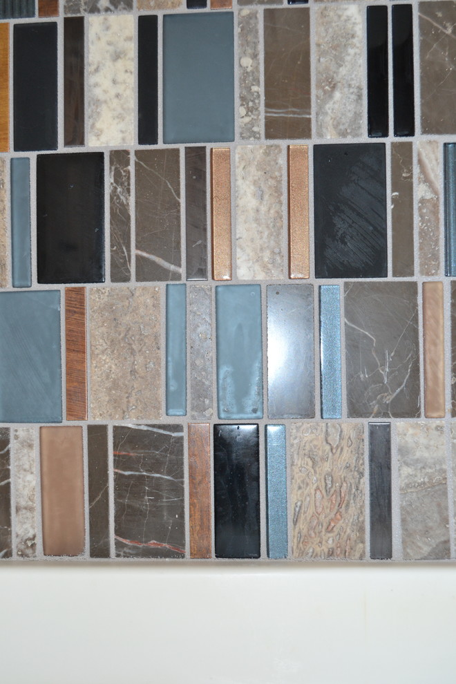 Mid-sized transitional kitchen photo with an integrated sink, raised-panel cabinets, multicolored backsplash and glass tile backsplash