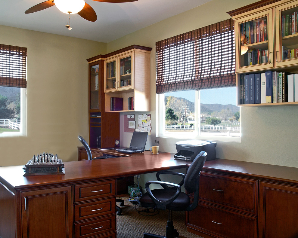 Inspiration for a mid-sized arts and crafts study room in Orange County with beige walls, carpet, a built-in desk, no fireplace and beige floor.