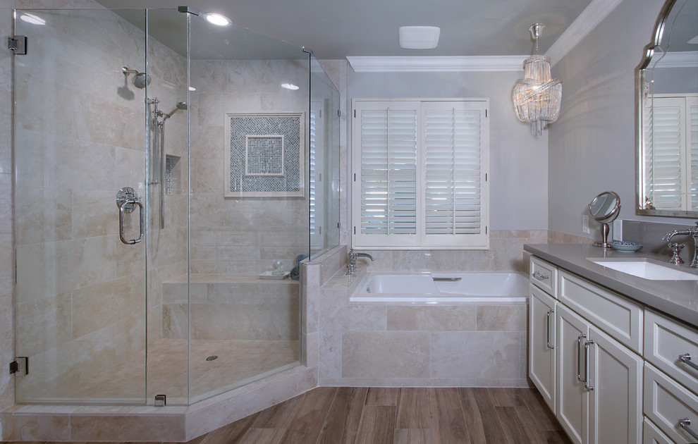 Drop-in bathtub - mid-sized transitional master beige tile and stone tile porcelain tile drop-in bathtub idea in Orange County with shaker cabinets, white cabinets, a one-piece toilet, gray walls, an undermount sink and quartz countertops