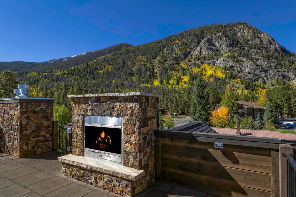 This is an example of a small country rooftop deck in Denver with a fire feature and no cover.
