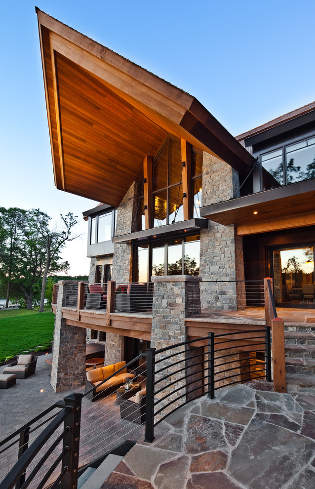 Design ideas for an expansive contemporary three-storey exterior in Minneapolis with stone veneer.