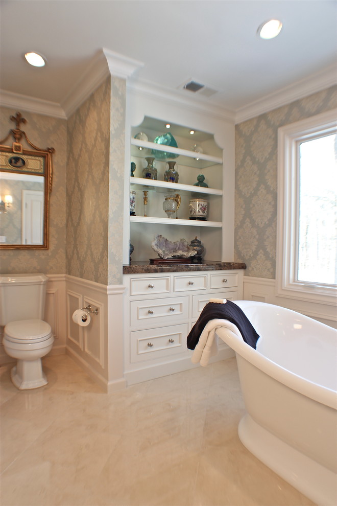 Inspiration for an expansive traditional master bathroom in New York with white cabinets, marble benchtops, a freestanding tub, a two-piece toilet, furniture-like cabinets, a corner shower, multi-coloured walls, ceramic floors, beige floor, a hinged shower door and grey benchtops.