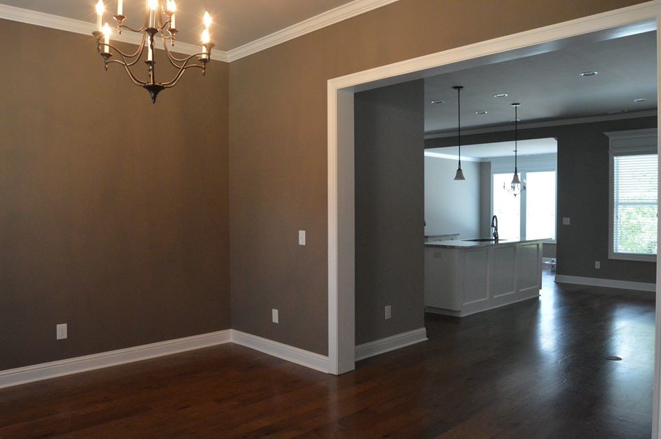 This is an example of a mid-sized traditional open plan dining in Other with brown walls, medium hardwood floors, no fireplace and brown floor.