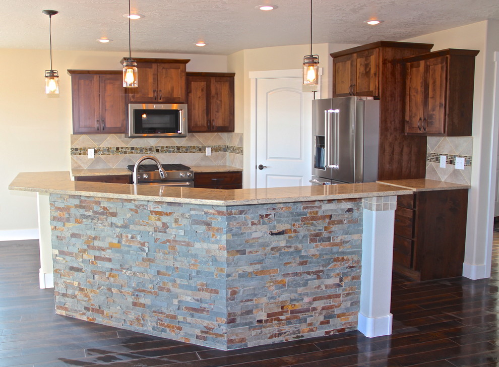 Inspiration for a rustic dark wood floor eat-in kitchen remodel with shaker cabinets, dark wood cabinets, beige backsplash, stainless steel appliances and an island