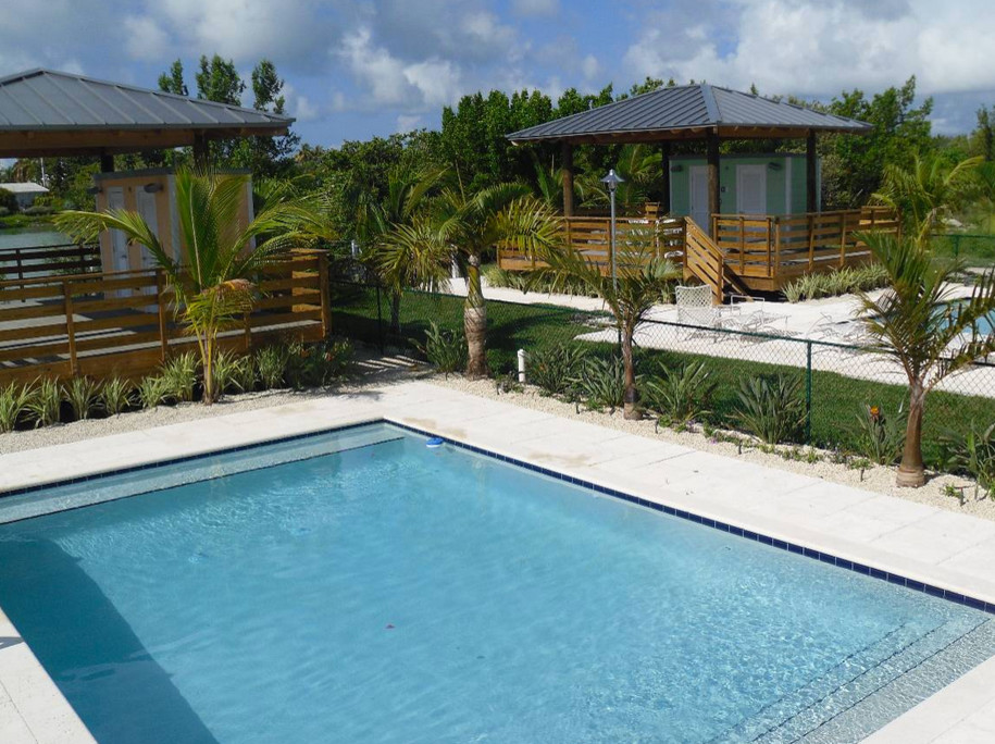 Hot tub - backyard tile and rectangular hot tub idea in Miami