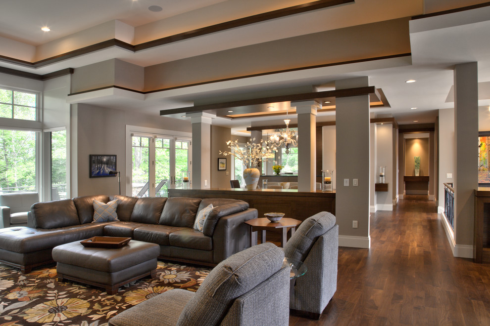 This is an example of a large modern formal open concept living room in Minneapolis with white walls, medium hardwood floors, a ribbon fireplace, a stone fireplace surround, a wall-mounted tv and brown floor.