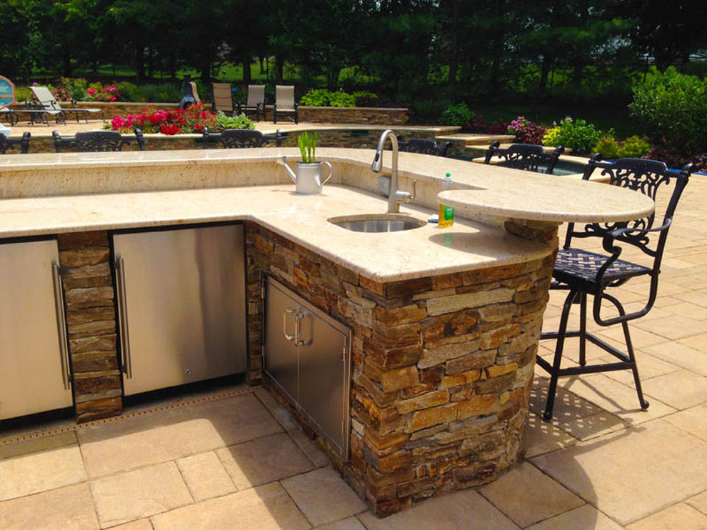 Mid-sized transitional backyard patio in New York with an outdoor kitchen, concrete pavers and no cover.