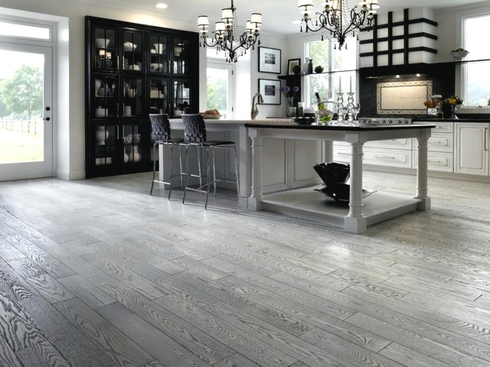 Eat-in kitchen - mid-sized transitional single-wall medium tone wood floor and gray floor eat-in kitchen idea in Orange County with beaded inset cabinets, white cabinets, solid surface countertops, black backsplash, ceramic backsplash, an island and black countertops