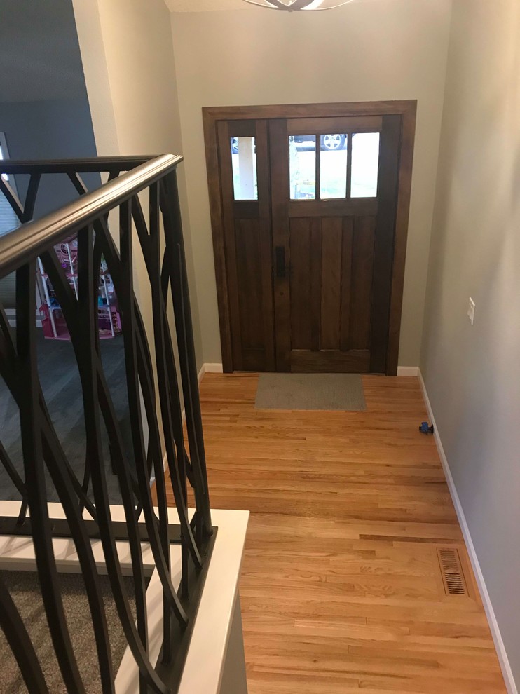 Mid-sized arts and crafts medium tone wood floor and brown floor front door photo in Seattle with gray walls and a dark wood front door
