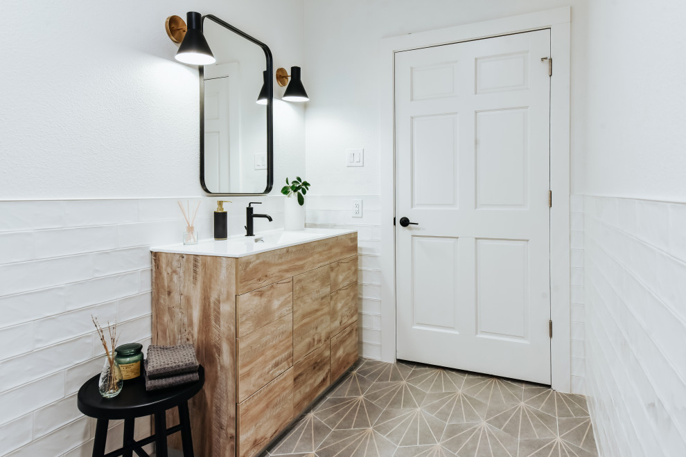 Medium sized modern cloakroom in Austin with flat-panel cabinets, light wood cabinets, white tiles, ceramic tiles, white walls, ceramic flooring, an integrated sink, engineered stone worktops, grey floors, white worktops and a freestanding vanity unit.