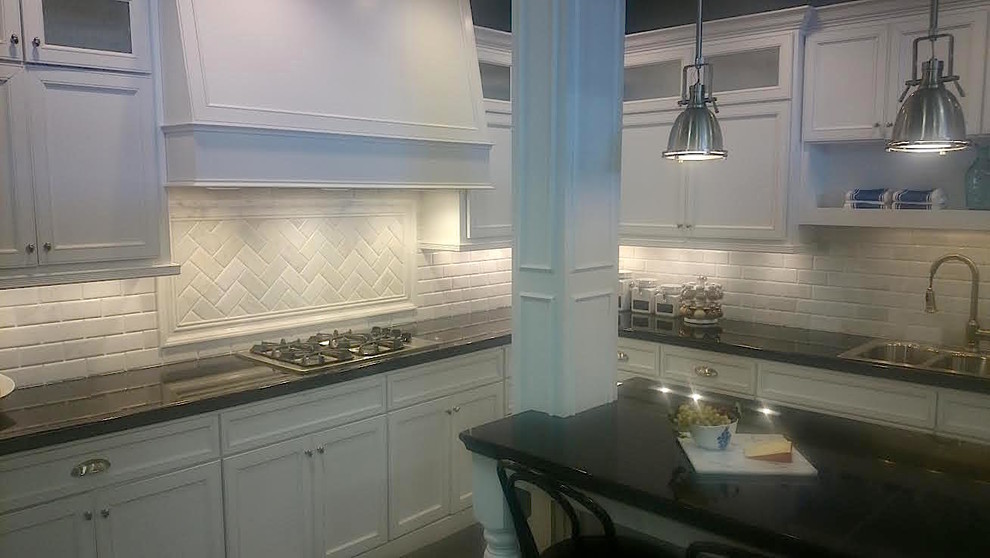 Mid-sized transitional l-shaped eat-in kitchen photo in Baltimore with a double-bowl sink, white cabinets, white backsplash, stainless steel appliances, an island, recessed-panel cabinets, quartz countertops and ceramic backsplash