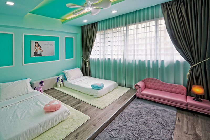 Mid-sized contemporary guest bedroom in Singapore with green walls and medium hardwood floors.