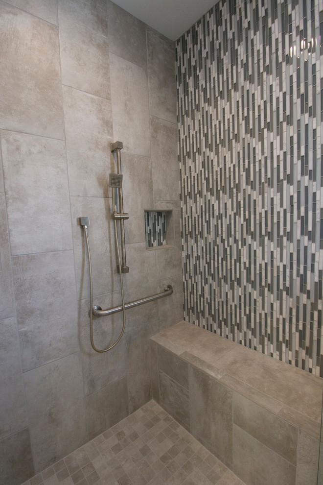 Walk-in shower - mid-sized transitional master gray tile and ceramic tile ceramic tile walk-in shower idea with an undermount sink, raised-panel cabinets, white cabinets, granite countertops, a two-piece toilet and gray walls