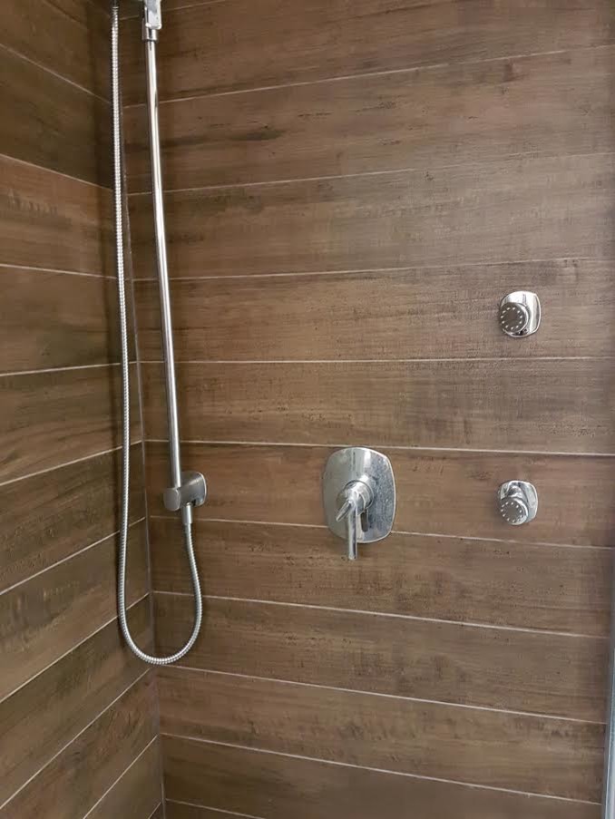 Inspiration for a mid-sized transitional master brown tile and porcelain tile slate floor and gray floor freestanding bathtub remodel in Orange County with white walls, open cabinets and dark wood cabinets