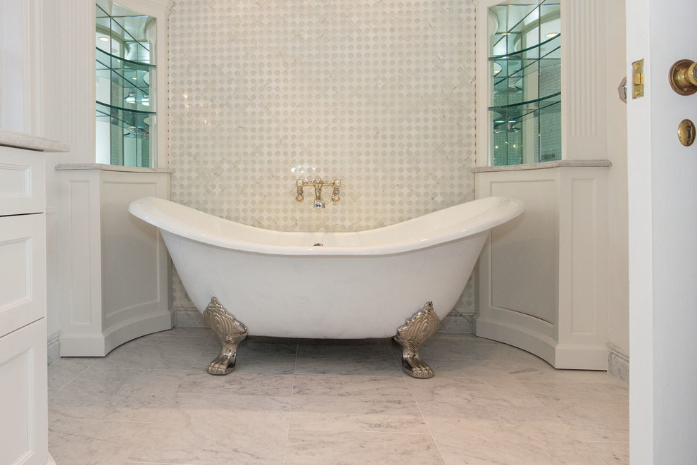 Inspiration for a mid-sized contemporary 3/4 bathroom in New York with beaded inset cabinets, white cabinets, a claw-foot tub, a corner shower, a one-piece toilet, gray tile, white tile, stone tile, white walls, marble floors, a drop-in sink and marble benchtops.