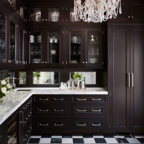 Traditional l-shaped kitchen pantry in New York with shaker cabinets, dark wood cabinets, marble benchtops, brown splashback, mirror splashback, panelled appliances, ceramic floors and with island.