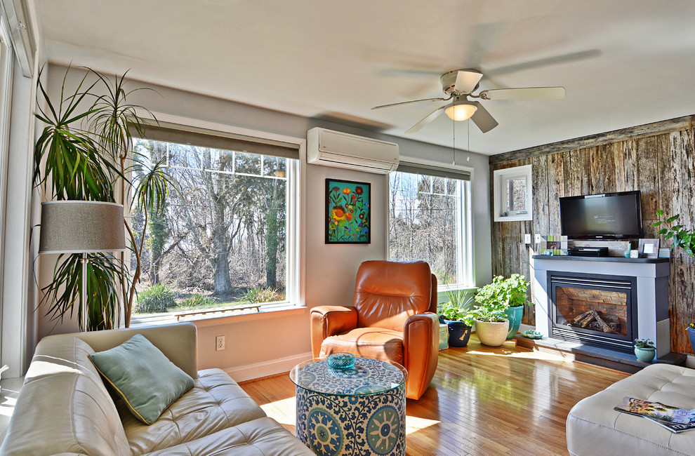 Mid-sized beach style sunroom in DC Metro with medium hardwood floors, a standard fireplace and a standard ceiling.