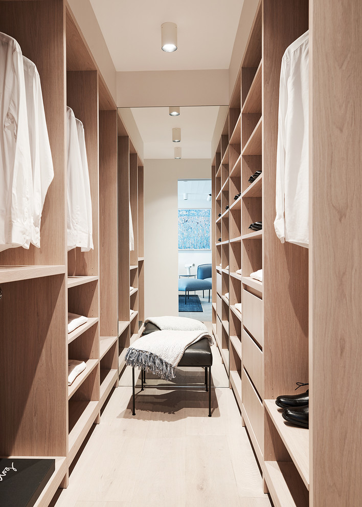 Inspiration for a contemporary gender-neutral walk-in wardrobe in Sydney with open cabinets, light wood cabinets, light hardwood floors and beige floor.