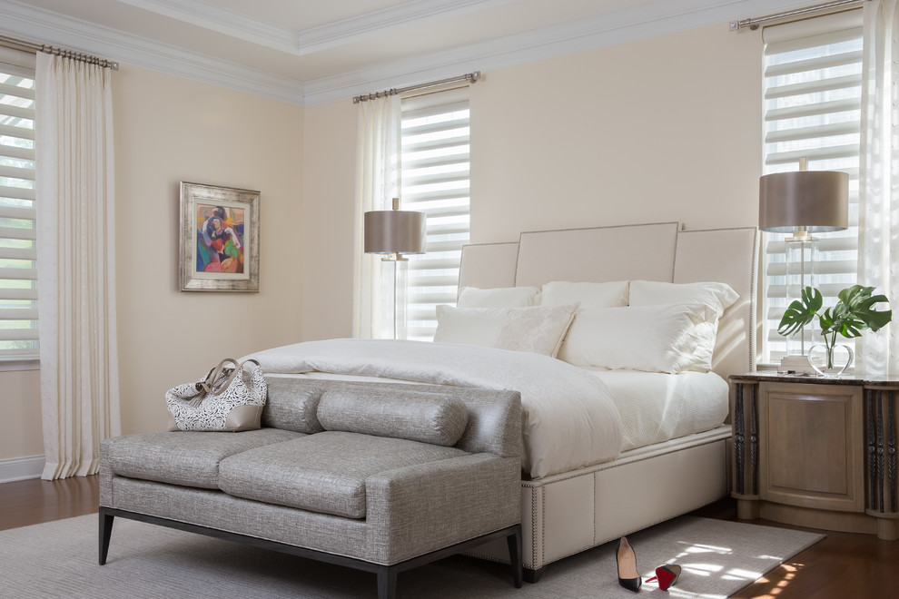 This is an example of an expansive contemporary master bedroom in Newark with beige walls, medium hardwood floors, brown floor and recessed.