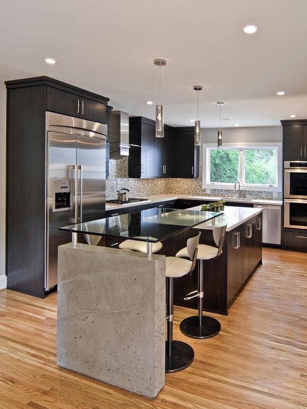 Example of a large transitional l-shaped light wood floor and brown floor enclosed kitchen design in Austin with an undermount sink, flat-panel cabinets, dark wood cabinets, solid surface countertops, gray backsplash, window backsplash, stainless steel appliances and an island