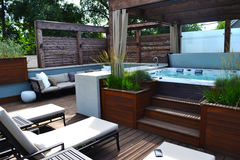 This is an example of a small contemporary rooftop deck in Chicago with a pergola.