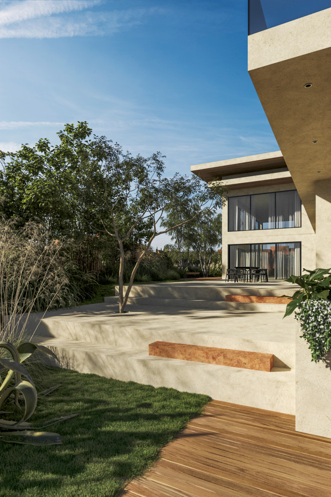 Immagine di un grande giardino minimalista esposto a mezz'ombra in cortile con pavimentazioni in pietra naturale