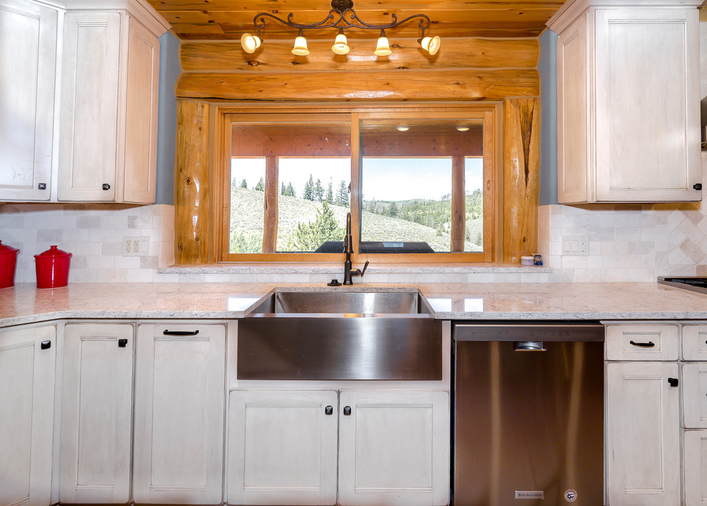 Mid-sized mountain style l-shaped beige floor enclosed kitchen photo in Denver with a farmhouse sink, medium tone wood cabinets, granite countertops, white backsplash, stainless steel appliances, an island and gray countertops