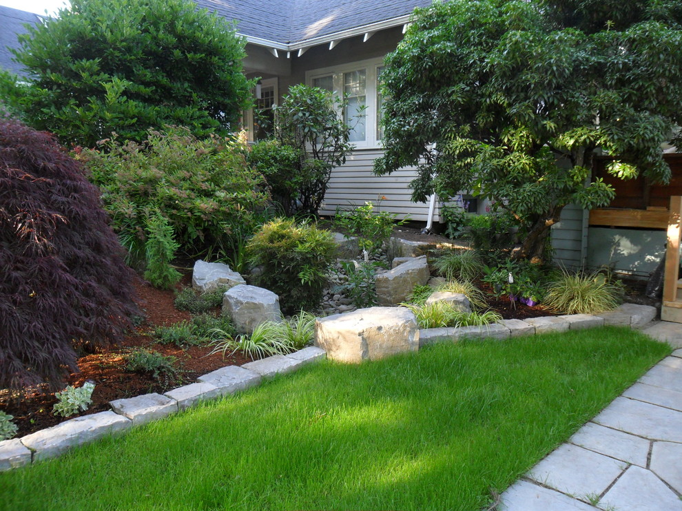 Design ideas for a small modern partial sun garden in Portland with with pond and natural stone pavers.