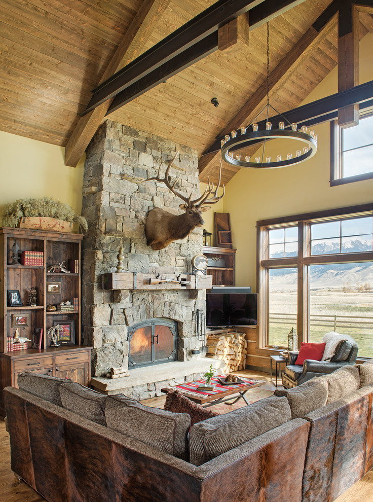 Inspiration for a country family room in Other with yellow walls, a standard fireplace and a corner tv.