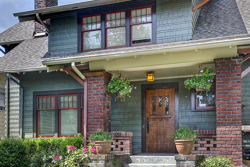 Design ideas for a large arts and crafts two-storey grey exterior in Seattle with wood siding.