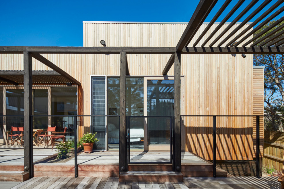 This is an example of a mid-sized contemporary two-storey exterior in Melbourne with wood siding.