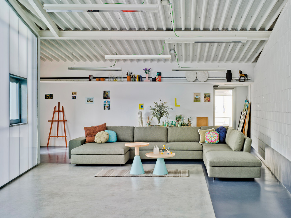 This is an example of a mid-sized industrial formal open concept living room in Other with white walls and no tv.