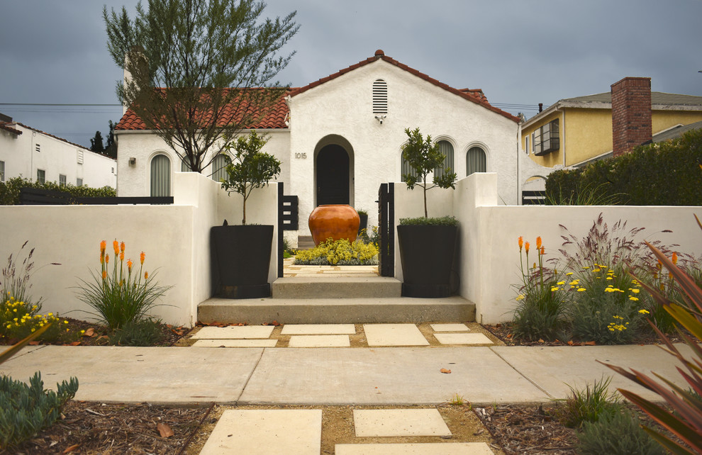 Inspiration for a small contemporary front yard full sun xeriscape with concrete pavers and a garden path.