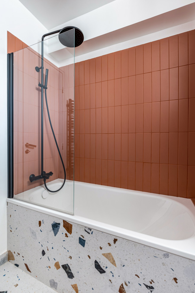 Пример оригинального дизайна: главная ванная комната среднего размера в стиле ретро с плоскими фасадами, белыми фасадами, полновстраиваемой ванной, душем над ванной, инсталляцией, оранжевой плиткой, красной плиткой, керамической плиткой, оранжевыми стенами, светлым паркетным полом, накладной раковиной, разноцветным полом, белой столешницей, тумбой под одну раковину, подвесной тумбой и душем с распашными дверями